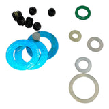 Set of mechanical parts including blue washers, black and green gaskets on a white background